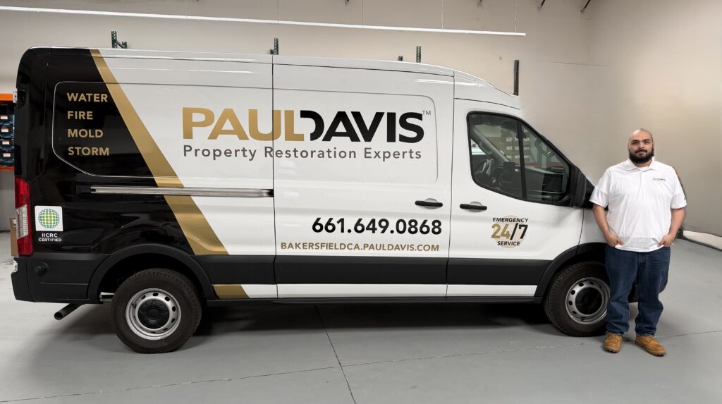 Paul Davis Restoration Bakersfield CA service van with technician standing beside it